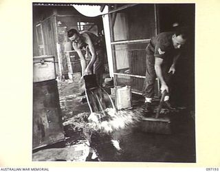 CAPE WOM, NEW GUINEA. 1945-09-27. PRIVATE J. CLARK (1) AND CORPORAL W.H. PHILLIPS (2), MEMBERS OF 2/7 FIELD AMBULANCE AT WORK IN THE KITCHEN