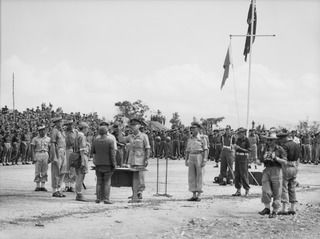 CAPE WOM, NEW GUINEA, 1945-09-13. A GENERAL VIEW OF THE SURRENDER CEREMONY AT CAPE WOM AIRSTRIP. LT-GEN H. ADACHI, COMD 18 JAPANESE ARMY IN NEW GUINEA, FORMALLY SURRENDERED TO MAJ-GEN H.C.H. ..