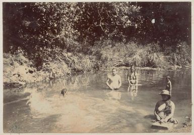 People swimming and doing laundry in a river. From the album: Cook Islands