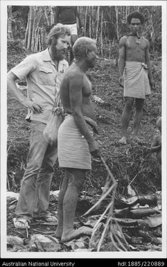 Unidentified researcher with Papuans