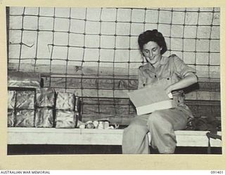 LAE, NEW GUINEA, 1945-05-06. STAFF-SERGEANT O.M.G. EDWARDS, COMPANY QUARTERMASTER SERGEANT, AUSTRALIAN WOMEN'S ARMY SERVICE BARRACKS, BUTIBUM ROAD, CHECKING EGG CUPS DURING PREPARATIONS FOR THE ..