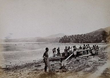 ["Fiji (?): islanders by a boat on the shore. Photograph, ca. 1880."]