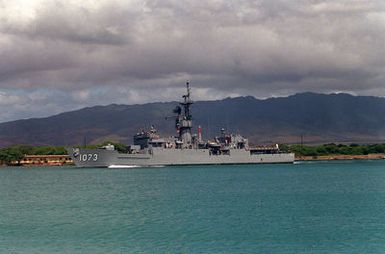 A port view of the frigate USS ROBERT E. PERRY (FF-1073) departing Pearl Harbor through the channel.