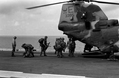 Marines of the 22nd Marine Expeditionary Unit (22nd MEU) board a Marine Medium Helicopter Squadron 261 (HMM-261) CH-46E Sea Knight helicopter aboard the amphibious assault ship USS SAIPAN (LHA 2) during a rehearsal for Operation Sharp Edge. The SAIPAN is on station off the coast of Liberia