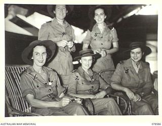 BOUGAINVILLE ISLAND. 1945-01-23. NFX76276 MATRON M.E. HURLEY (4) WITH QFX19161 SISTER E.M. ALLEN (1) QFX19159 SISTER E.M. DUFFIELD (2) AND QFX23785 SISTER B.M. FOLEY (3) RELAXING IN THE SISTER'S ..