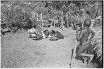 Distribution of wild pig meat: children by fence near large pieces of pork