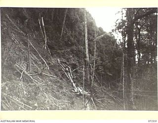 MISSION HILL, NEW GUINEA. 1944-04-06. ROCK FACE CUT OVER MISSION HILL SHOWING DIFFICULTIES OF TERRAIN ENCOUNTERED BY THE 23RD LINE SECTION, 18TH LINES OF COMMUNICATION SIGNALS