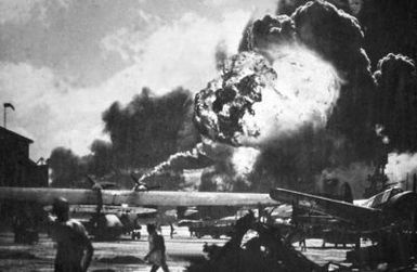 Aircraft at Hickam Field, Hawaii (HI) continue to burn and explode, in the immediate aftermath of the bombing of Pearl Harbor and other military installations