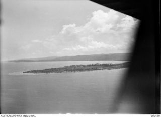 CAPE MOEM, NEW GUINEA, 1945-09-12. AERIAL VIEW OF CAPE MOEM. DURING THE ADVANCE ALONG THE COAST FROM DAGUA TO CAPE MOEM, 2/8 INFANTRY BATTALION PROBED EASTWARDS TOWARDS CAPE MOEM, STRIKING HEAVY ..