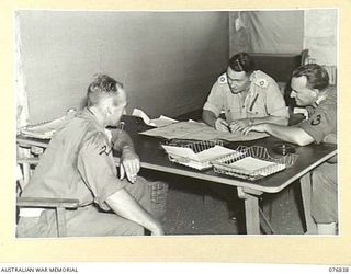 LAE, NEW GUINEA. 1944-11-11. VX104013 MAJOR I.A. WILSON, COMMANDING OFFICER (1), NX112703 CAPTAIN O. HEWISON-COOPER, ADJUTANT (2) AND NX125289 CAPTAIN G.H. CHAPMAN, CHIEF STAFF OFFICER (3) OF THE ..