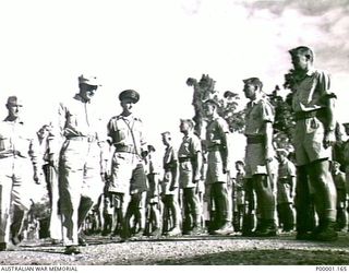 THE SOLOMON ISLANDS, 1945. AMERICAN MAJOR GENERAL R.J. MITCHELL REVIEWING NEW ZEALAND SERVICE PERSONNEL AT A PARADE HELD ON BOUGAINVILLE ISLAND BEFORE THE GENERAL'S DEPARTURE FROM THE ISLAND. ..