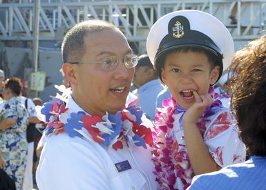 US Navy (USN) CHIEF Electricians Mate (Surface Warfare) (EMC(SW)) Martinez greets his family after a nine month separation. EMC(SW) Martinez and his ship the USN Arleigh Burke Class Guided Missile Destroyer, USS PAUL HAMILTON (DDG 60) returned home to Pearl Harbor, Hawaii (HI), from an Operation IRAQI FREEDOM deployment
