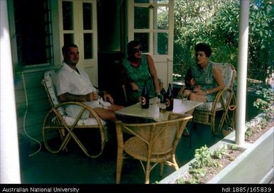 Two women and a man on a porch