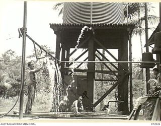 MILNE BAY, NEW GUINEA. 1944-04-04. VX114760 SAPPER I.I. ALLEN (1), AND VX136348 SERGEANT J.H. HAWKINS (2), MEMBERS OF THE 5TH ARMY TROOPS COMPANY, QUEENSLAND LINES OF COMMUNICATION AREA, ROYAL ..