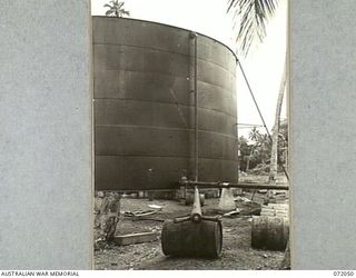 MILNE BAY, NEW GUINEA. 1944-04-04. THE "Y" CONNECTION IN THE FOREGROUND CONNECTS TO THE 12,000 GALLON PETROL STORAGE TANK IN THE BACKGROUND AT THE 2ND BULK PETROLEUM STORAGE COMPANY. THE "Y" PIECE ..