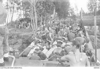 JABA RIVER AREA, BOUGAINVILLE, SOLOMON ISLANDS. 1944-12-18. 15 INFANTRY BATTALION SUPPORT TROOPS EMBARKING BY BARGE FOR TRANSPORT TO D COMPANY'S NEW POSITION ON THE SOUTH BANK OF THE JABA RIVER. ..