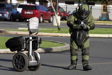 U.S. Marine Corps SGT. Pretz, Explosive Ordnance Disposal SPECIALIST, Combat Service Support Group-3, looks at the images taken on a digital camera of a car suspected to contain a simulated bomb during training at the Marine Corps Base Hawaii, Hawaii, Post Exchange parking lot on Dec. 9, 2004.(U.S. Marine Corps official photo by CPL. Nicholas Riddle) (Released)