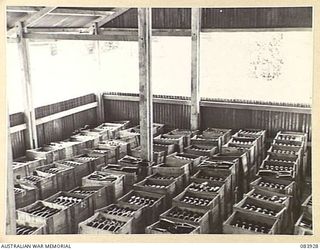 LAE, NEW GUINEA. 1944-12-12. A SECTION OF THE BOTTLING ROOM OF A SOFT DRINK FACTORY OPERATED WITHIN LAE BASE SUB-AREA. THE CRATES AWAIT DISTRIBUTION THROUGH THE ARMY CANTEENS SERVICE