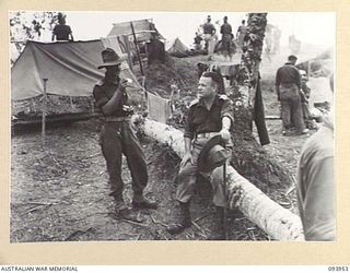 ULUPU, NEW GUINEA, 1945-07-09. CAPTAIN G.M. FRY, OFFICER COMMANDING D COMPANY, 2/5 INFANTRY BATTALION (1), WITH BRIGADIER M.J. MOTEN, COMMANDING OFFICER, 17 INFANTRY BRIGADE (2), DISCUSSING THE ..