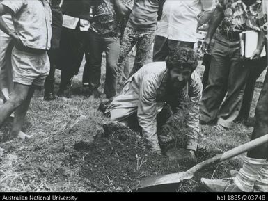 Bill Standish planting a tree in Kundiawa, Papua New Guinea on Independence Day on behalf of ANU researchers who have worked in the Chimbu District of PNG