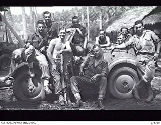 MILILAT, NEW GUINEA. 1944. PERSONNEL OF THE TRANSPORT SECTION, HEADQUARTERS, 5TH DIVISION POSE FOR THEIR PHOTOGRAPH WITH A CAPTURED JAPANESE, DKW SCOUT CAR (GERMAN PATTERN)