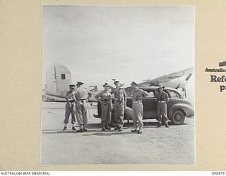 JACQUINOT BAY, NEW BRITAIN. 1945-04-09. SENATOR J.M. FRASER, ACTING MINISTER FOR THE ARMY (3), AND SENIOR OFFICERS ON ARRIVAL AT THE AIRSTRIP. THE OFFICIAL PARTY WISHED TO STUDY THE AIRSTRIP WHICH ..