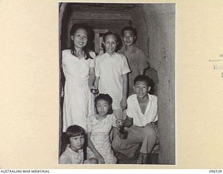 RABAUL AREA, NEW BRITAIN. 1945-09-13. CHINESE CIVILIANS, INTERNED BY THE JAPANESE AT A CAMP 15 MILES WEST OF RABAUL, WERE CONTACTED BY A PARTY OF AUSTRALIAN ARMY AND RED CROSS OFFICIALS SOON AFTER ..