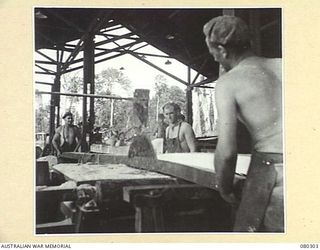 BUSU FOREST, LAE AREA, NEW GUINEA. 1944-07-26. AT NO.2 RIP BENCH OF THE 2/3RD FORESTRY COMPANY, ROYAL AUSTRALIAN ENGINEERS, SMALLER FLITCHES ARE SAWN INTO BOARDS