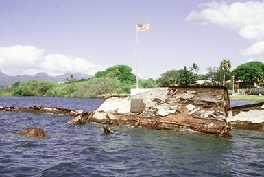 A view of the wreck of the former battleship/target ship USS UTAH (BB-31, AG-16), which was sunk at its moorings on the west side of Ford Island on December 7, 1941, during the Japanese attack on Pearl Harbor