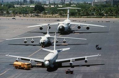 A KC-135 Stratotanker, C-141B Starlifter and C-5A Galaxy aircraft parked on the flight line