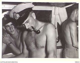 SIMPSON HARBOUR, NEW BRITAIN. 1945-10-13. THE WHEEL HOUSE OF THE MOTOR LAUNCH 825, ROYAL AUSTRALIAN NAVY. THE VESSEL IS THE ONLY MOTOR LAUNCH IN THE SOUTH WEST PACIFIC AREA TO BRING DOWN A JAPANESE ..