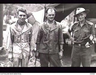 PORT MORESBY, NEW GUINEA. 1943-11-14. TEST PHOTOGRAPH TAKEN BY WARRANT OFFICER R. IRVING, PHOTOGRAPHER OF MILITARY HISTORY SECTION, SHOWING TWO UNITED STATES SOLDIERS WITH SERGEANT R. J. BUCHANAN, ..