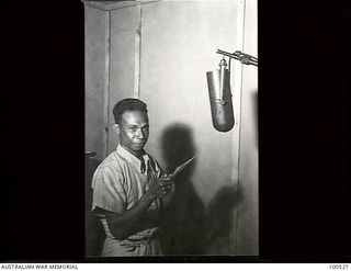 Port Moresby, New Guinea. 1944-07-22. Morea Hila, a Papuan native announcer, broadcasting from the Radio Station 9PA. Aged 32, he was educated at the London Missionary School at Hanuabada and ..