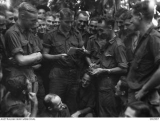 WEWAK AREA, NEW GUINEA, 1945-06-09. MR. F. SIMPSON, ABC WAR CORRESPONDENT (1), INTERVIEWING PTE W.R. PASSULA, B COMPANY, 2/8 INFANTRY BATTALION (2)