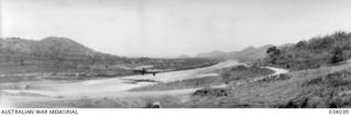 Kila Kila, Papua. 1942-08. The airstrip on the coast close to Port Moresby with an United States Air Force C47 transport aircraft on final approach