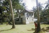 Federated States of Micronesia, village boy outside home in Chuuk State