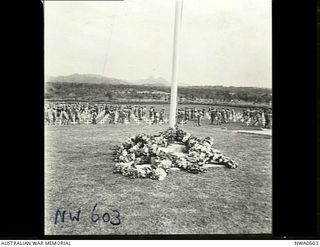 Port Moresby, Papua. 1944-08-05. Wreaths placed at the base of the flagpole after the opening ceremony of the Bomana War Cemetery