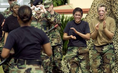 U.S. Air Force 13th Air Force Capts. Michelle Olsen (right), and Rebeccah Gervansini (2nd from right), cheer on 1ST LT. Maia Susuico through an obstacle course during Warrior Day Challenge at Arch Light Memorial Park, Andersen Air Force Base, Guam, on Jan. 14, 2005. (U.S. Air Force PHOTO by STAFF SGT. Bennie J. Davis, III) (RELEASED)