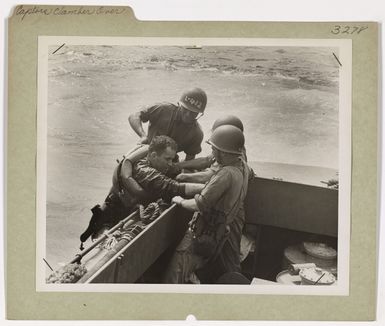 Photograph of Coast Guardsman Being Assisted in Boarding a Landing Craft