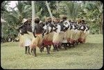 Dancers in grass skirts and matching headress