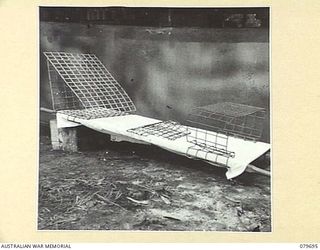 ORO BAY, NEW GUINEA. 1943-07. A BACK REST, "DONKEY", AND BED TABLE IMPROVISED FROM A.R.C. MESH BY MEMBERS OF THE 10TH FIELD AMBULANCE, AUSTRALIAN ARMY MEDICAL CORPS