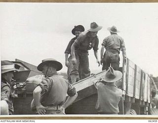 POM POM PARK, PORT MORESBY AREA, PAPUA, NEW GUINEA. 1944-01-05. NX51600 LIEUTENANT A. P. HAMILTON (1); INTELLIGENCE OFFICER, 57/60TH AUSTRALIAN INFANTRY BATTALION SUPERVISING THE LOADING OF STORES ..