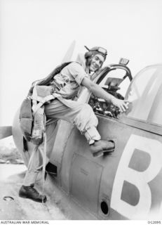 TOROKINA, BOUGAINVILLE ISLAND, SOLOMON ISLANDS. C. 1945-01-16. 400966 FLIGHT LIEUTENANT H. L. M. AGG, BRIGHTON, VIC, CLIMBING INTO HIS AUSTRALIAN BUILT BOOMERANG AIRCRAFT OF NO. 5 (ARMY ..