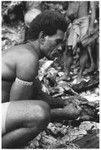 Larikeni of Furingudu measuring out kofu shell money to purchase packets of fish at market with sea people