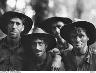 Members of  A Company, 2/12th Battalion who helped silence a Japanese mountain gun on Mount Prothero. This image has also been identified as (from left to right) members of B Company; NX86190 A ..