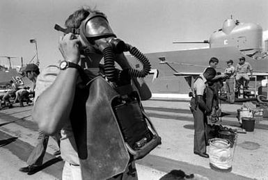 Crewmen test oxygen breathing apparatus during Damage Control Olympics at the Bravo Piers