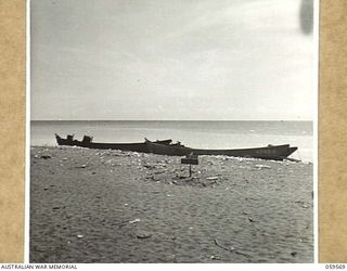 FINSCHHAFEN AREA, NEW GUINEA, 1943-10-23. THIRTY NINE JAPANESE WERE KILLED DURING THE INITIAL LANDING ON SCARLET BEACH. IN THE CENTRE OF THE PICTURE CAN BE SEEN A JAPANESE GRAVE WHILE IN THE ..