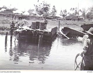 MADANG, NEW GUINEA. 1944-08-18. THE MEDICAL LAUNCH AM1567 OF THE NEW GUINEA SEA AMBULANCE TRANSPORT COMPANY PULLING INTO THE WHARF OF THE 2/11TH HOSPITAL ON HER RETURN FROM ALEXISHAFEN PICKING UP ..