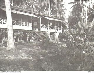 KARKAR ISLAND, NEW GUINEA. 1944-10-20. NX6543 CAPTAIN V.W. MAXWELL (1), AND NX14320 SERGEANT B. DE LEWIS (2), OUTSIDE A PLANTATION HOUSE RE-CONDITIONED BY NATIVES WORKING UNDER THE DIRECTION OF THE ..