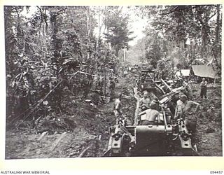 SOUTH BOUGAINVILLE. 1945-07-29. A TRACTOR TRAIN OF 29 INFANTRY BRIGADE BOGGED IN THE QUAGMIRE WHICH ONCE WAS THE BUIN ROAD, OUR MAIN SUPPLY ROUTE. AS A RESULT OF HEAVY RAINS TRAFFIC IS HELD UP EAST ..